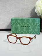 Gucci eyeglasses with warm brown acetate frame, rectangular lenses, gold accents