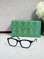 Gucci eyeglasses with black acetate frame, rectangular lenses, gold temple details