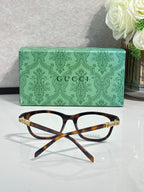 Gucci eyeglasses with tortoise-brown frames and clear lenses, angled view
