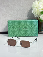Silver rectangular sunglasses with brown lenses and slim black arms