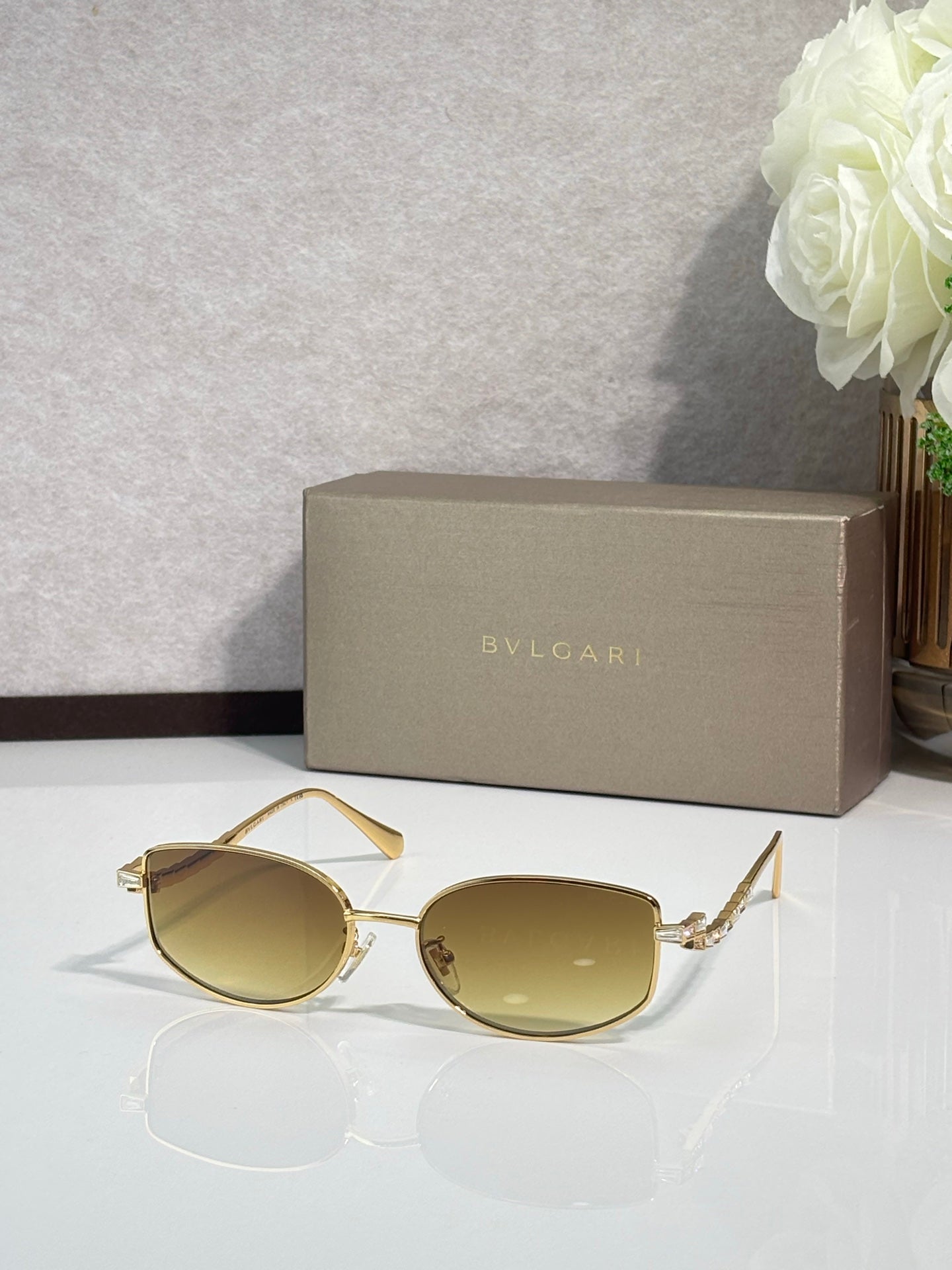 Bvlgari sunglasses with gold frame and pale yellow lenses