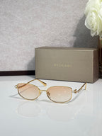 Bvlgari sunglasses with gold frame and light amber lenses