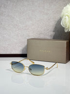 Bvlgari sunglasses with gold frame and teal blue lenses