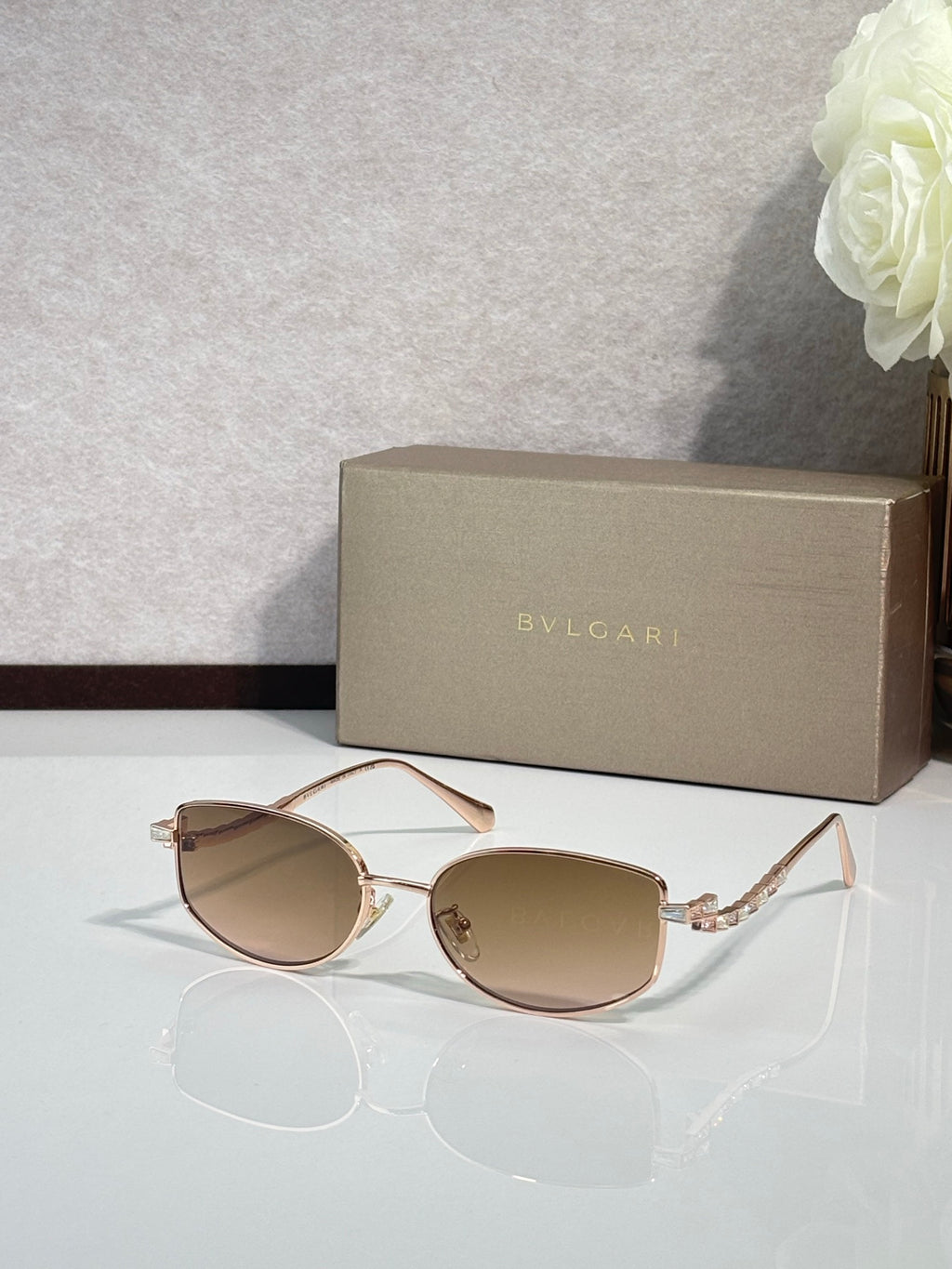 Bvlgari sunglasses with rose-gold frame and tan lenses