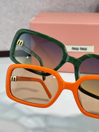 MiuMiu green and orange sunglasses, close-up of frames with gold logo