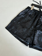 Gucci floral print shorts, dark patterned fabric with drawstring ties