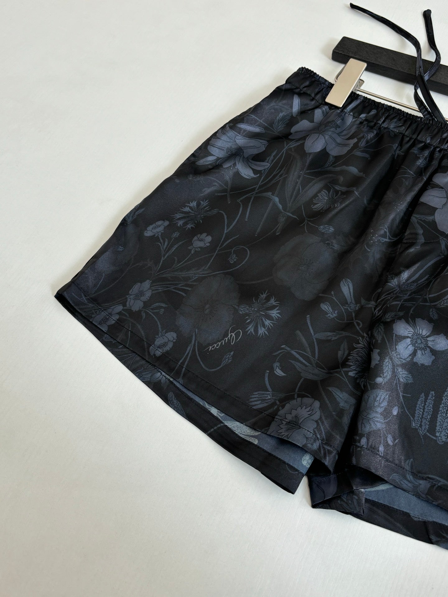 Gucci floral print shorts, dark patterned fabric with drawstring ties