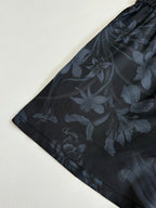 Gucci floral print shorts, dark fabric with flower motif, flat lay