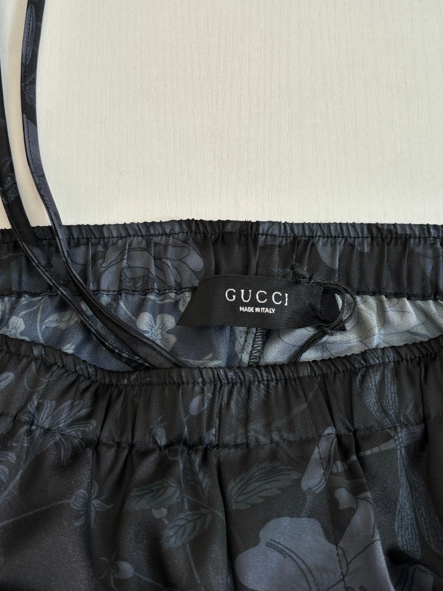 Gucci shorts waistband label, dark floral print, elastic drawstring