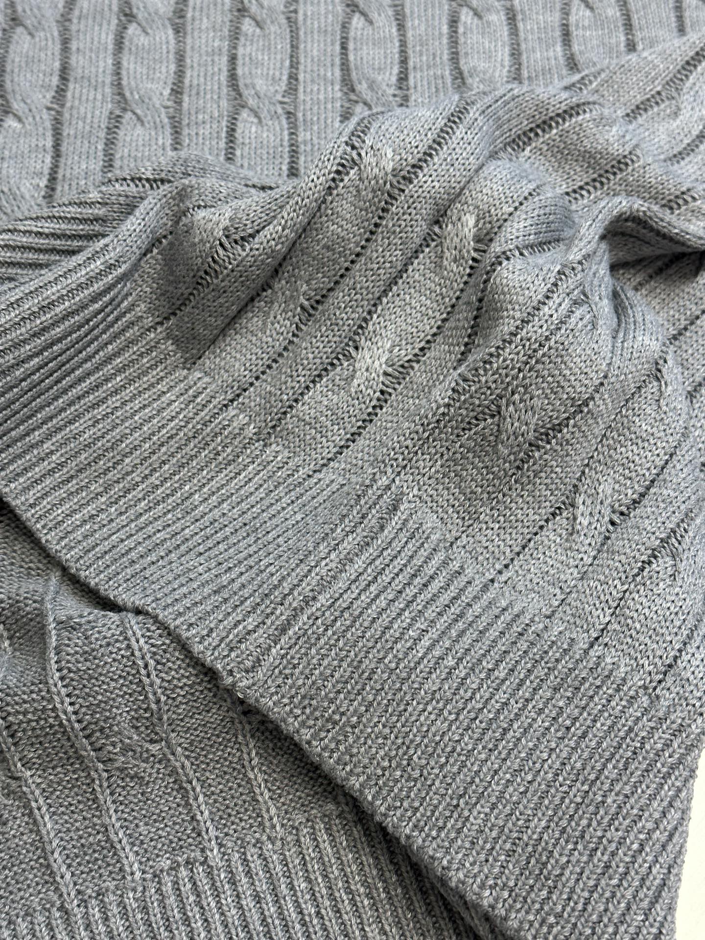Light gray cable-knit fabric with folded hem detail