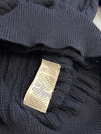 Navy polo shirt with stitched fabric label at the neck opening