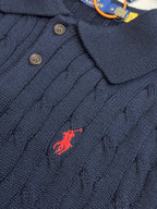 Navy knit polo shirt with dark buttons and embroidered red horse logo