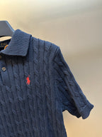 Navy cable-knit polo shirt sleeve and embroidered red horse logo