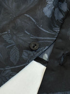 Gucci shirt sleeve close-up with button and blue floral fabric pattern