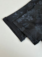 Gucci shorts front view, dark fabric with blue floral print