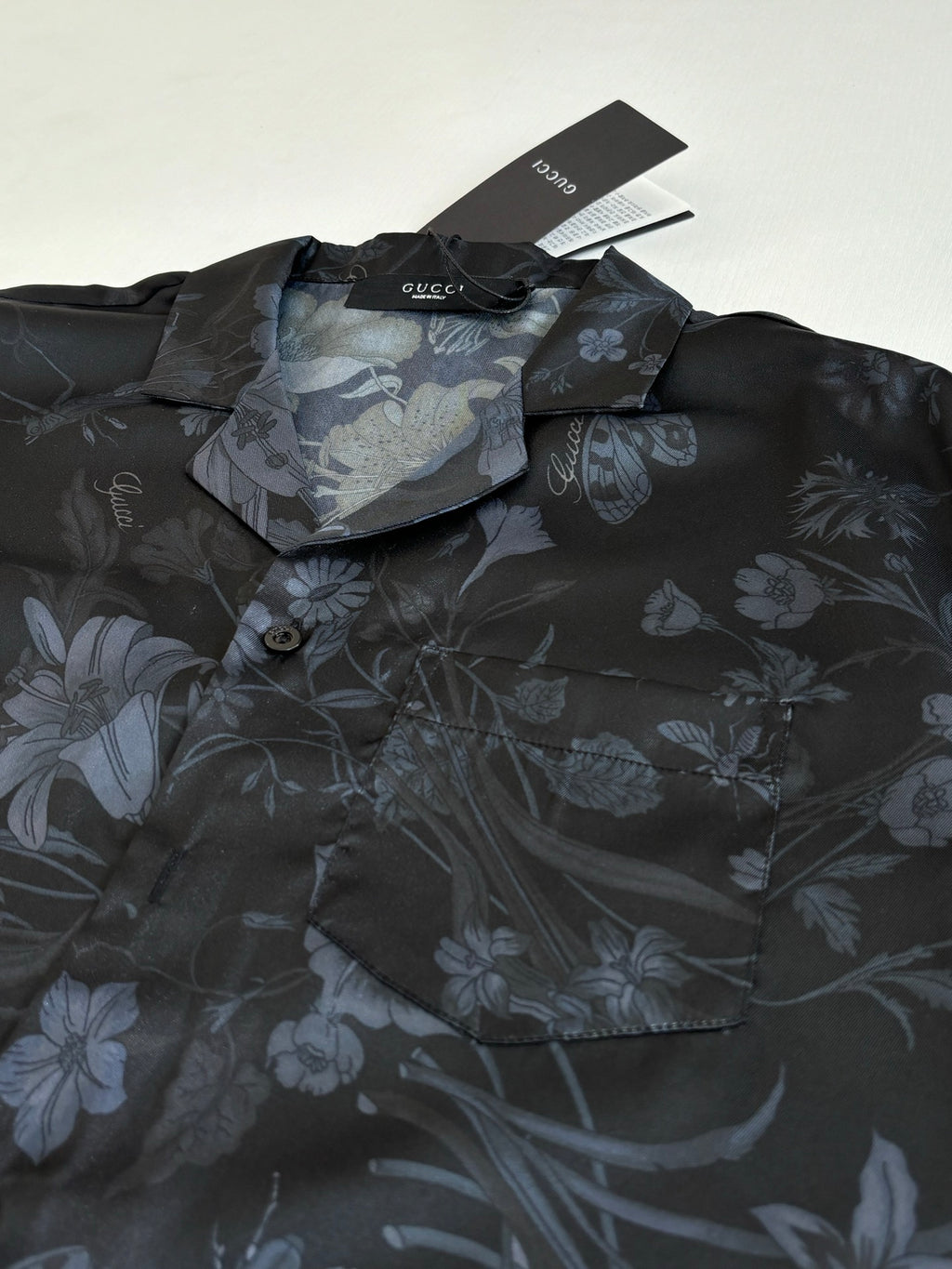 Gucci short-sleeve shirt detail, dark fabric with blue floral pattern