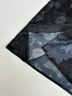 Gucci shorts close-up, dark with blue floral pattern and inner lining