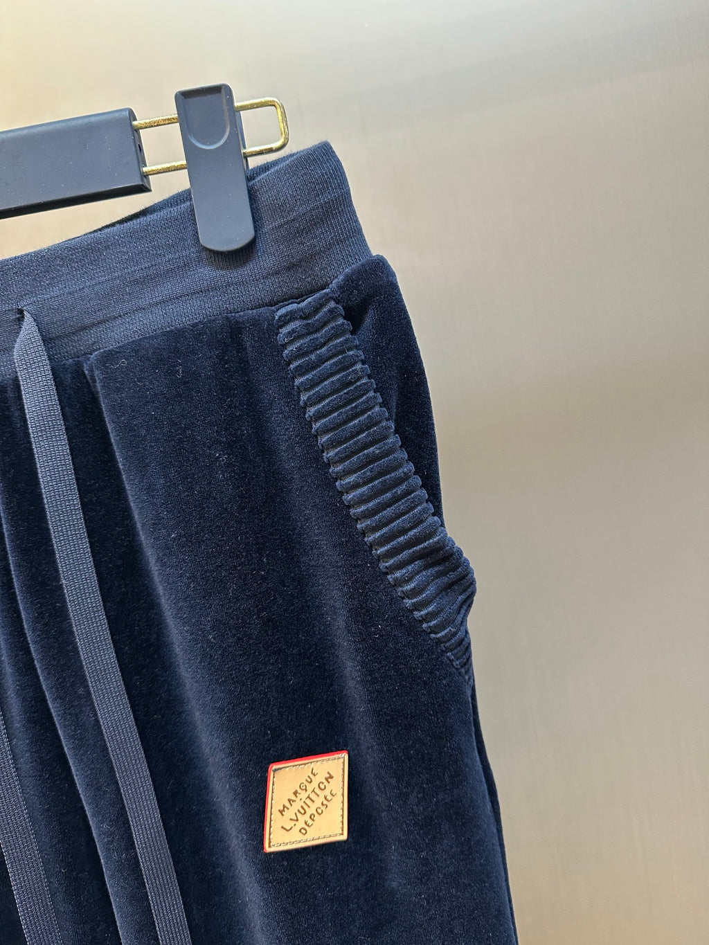 Louis Vuitton pants close-up, dark navy ribbed waistband and textured side seam
