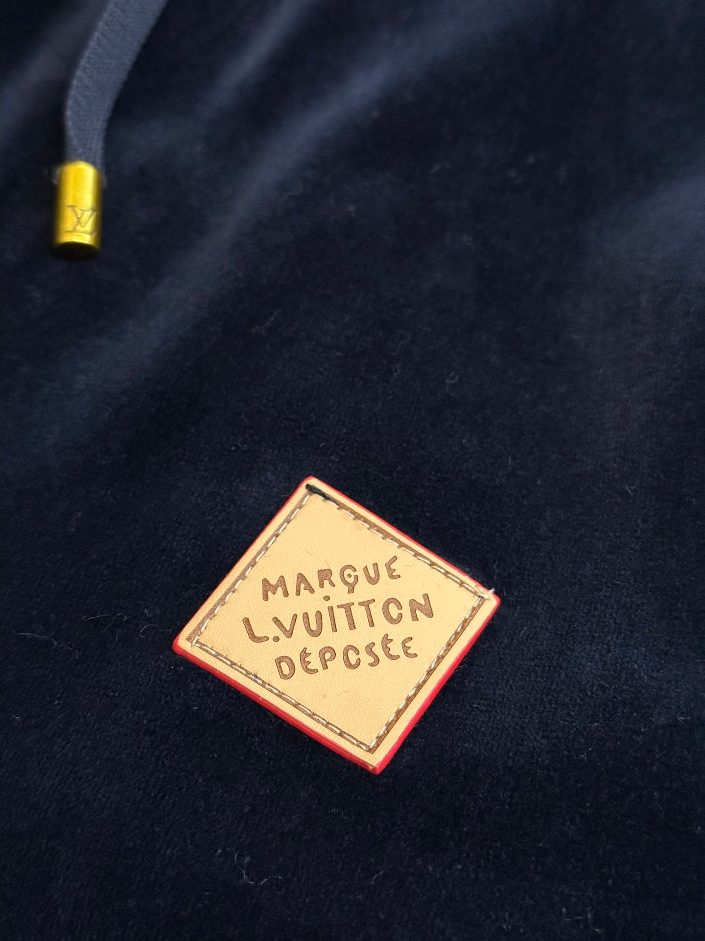 Louis Vuitton brand label patch on dark navy pants