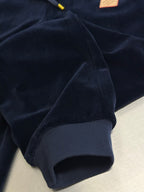 Louis Vuitton pants fabric close-up, dark navy velour texture with rib-knit cuff