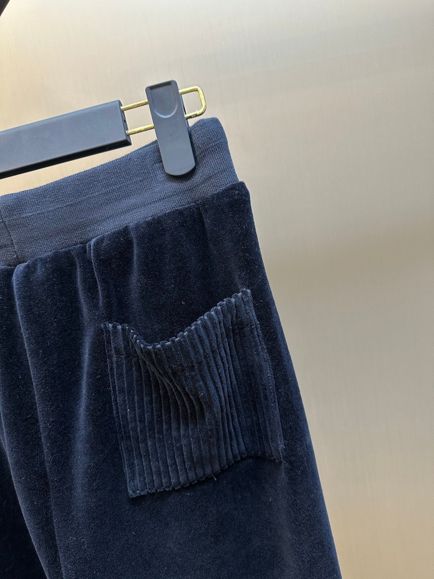 Louis Vuitton pants close-up, dark navy pocket detail and rib-knit hem