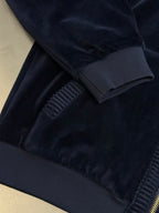 Navy jacket sleeve cuff and ribbed trim with gold zipper seam