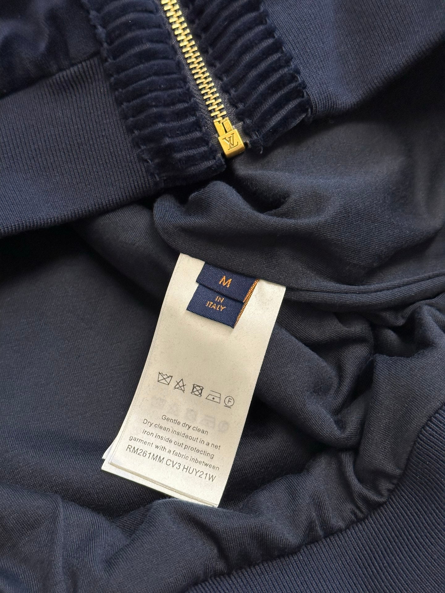 Navy jacket interior neck tag and gathered zipper placket