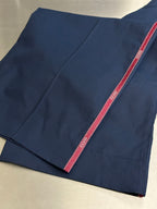 Navy pants with red side stripe, folded fabric view