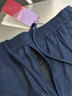 Navy pants with zip opening and red-trim pocket seam