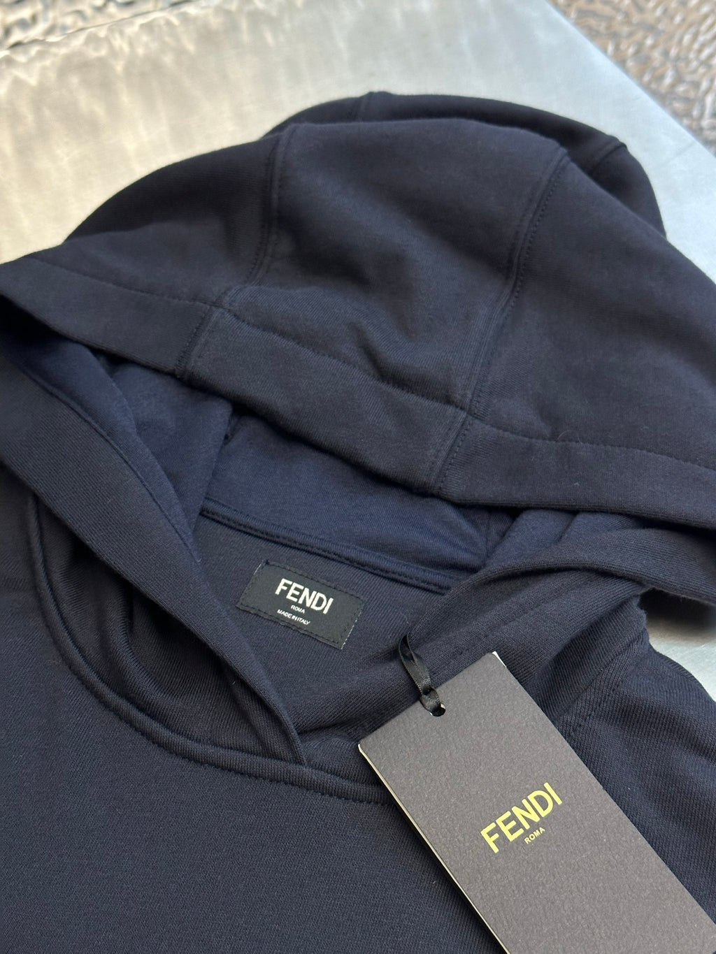 Navy hoodie hood lining with FENDI brand tag and size label