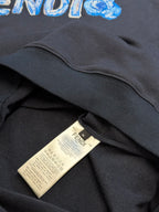 Navy hoodie with white care label near ribbed hem