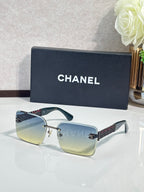 Chanel sunglasses with dark blue lenses and gold chain temple accents, rectangular frames