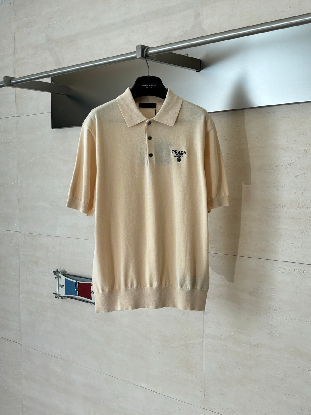 Beige short-sleeve polo shirt with buttoned collar and small chest logo
