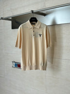 Beige short-sleeve polo shirt with buttoned collar and small chest logo