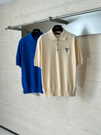 Two short-sleeve polo shirts on hangers: beige and blue