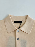 Beige polo shirt collar with two buttons and black interior neckline tag