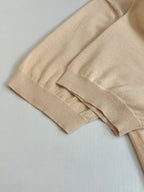 Beige polo shirt sleeve and cuff detail with ribbed knit trim