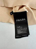 Beige polo shirt care label and size tag showing Prada branding