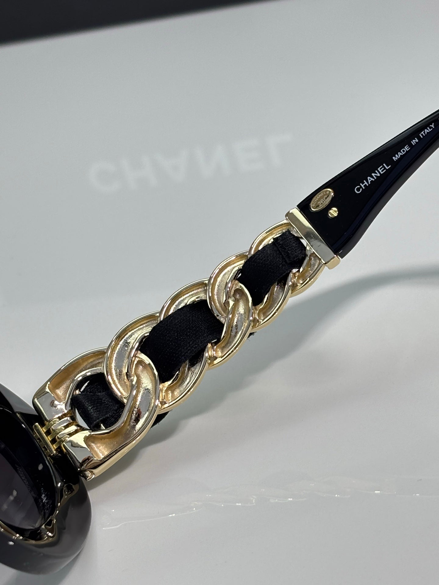 Black sunglasses chain strap with gold-tone links