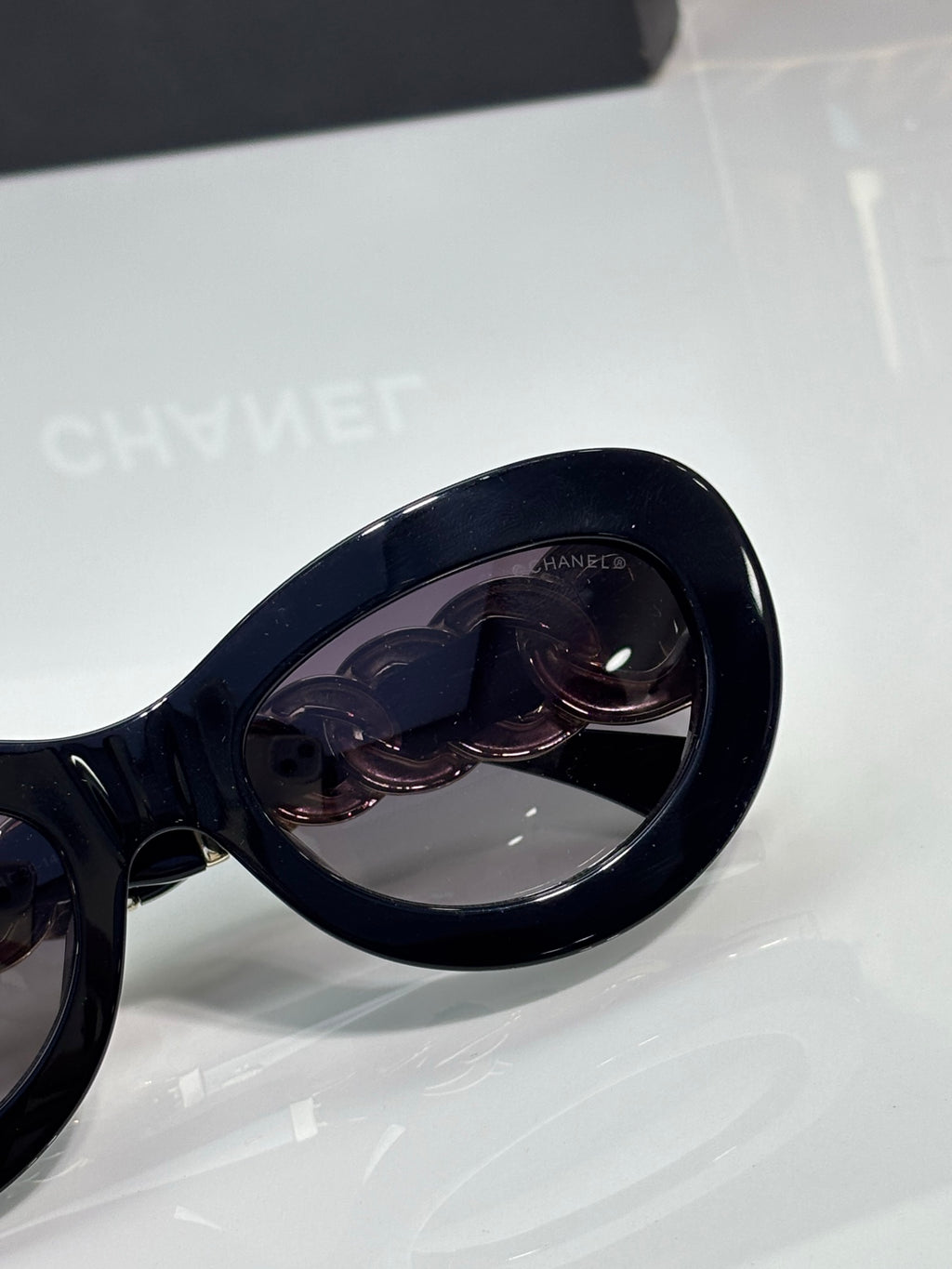 Black sunglasses temple tip with mirrored lens and dark frame