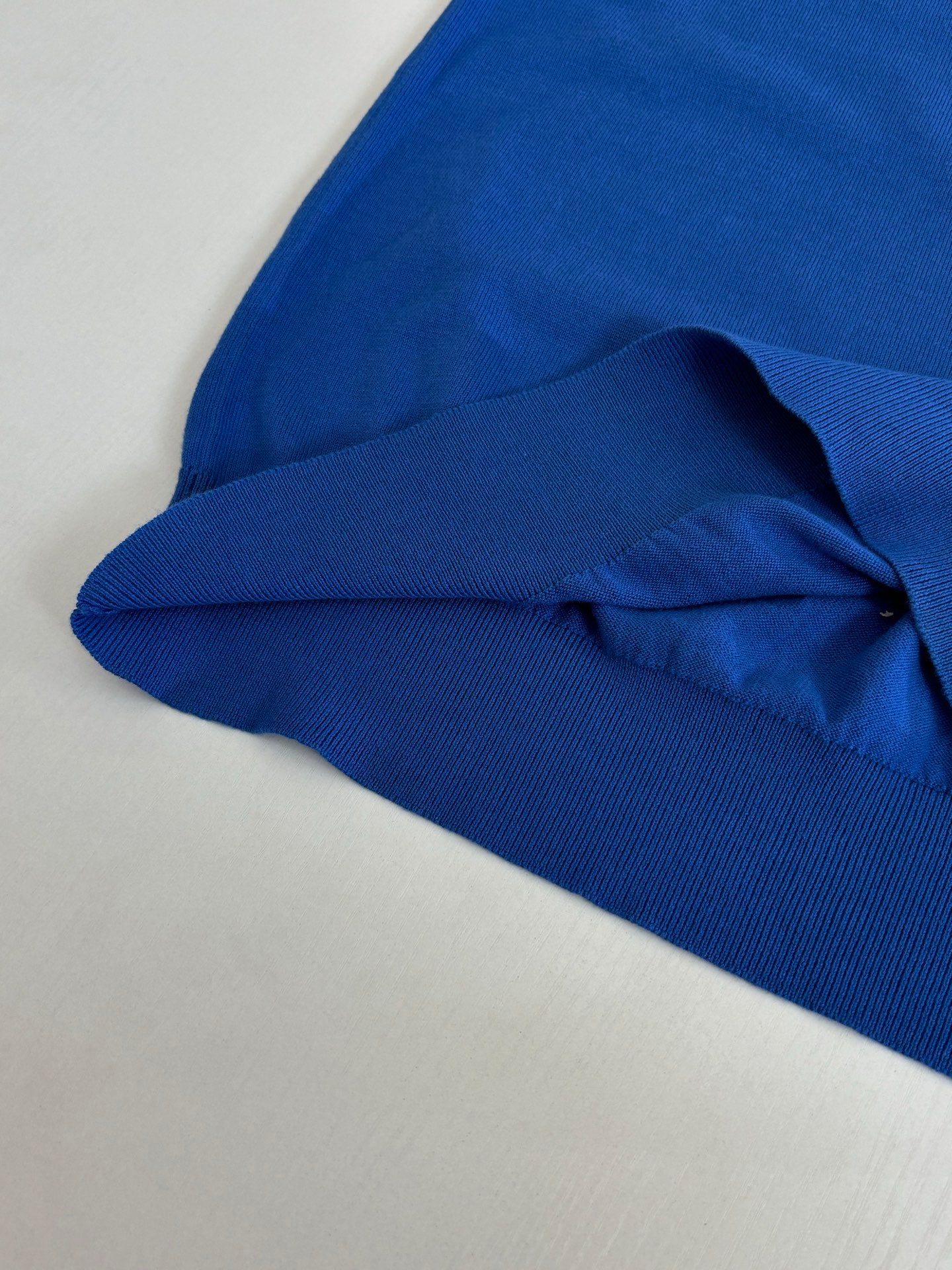 Blue polo shirt sleeve and ribbed hem detail