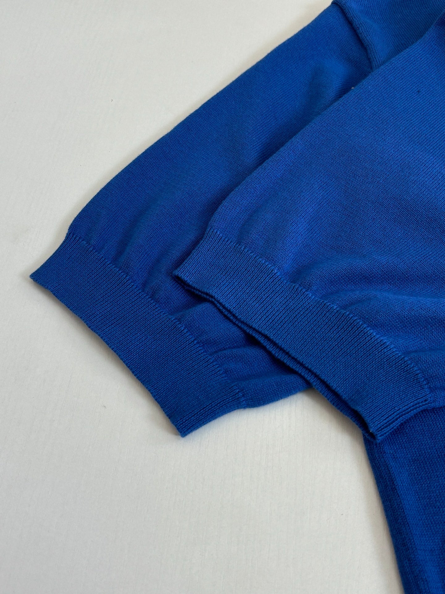 Blue polo shirt folded sleeve and ribbed cuff detail