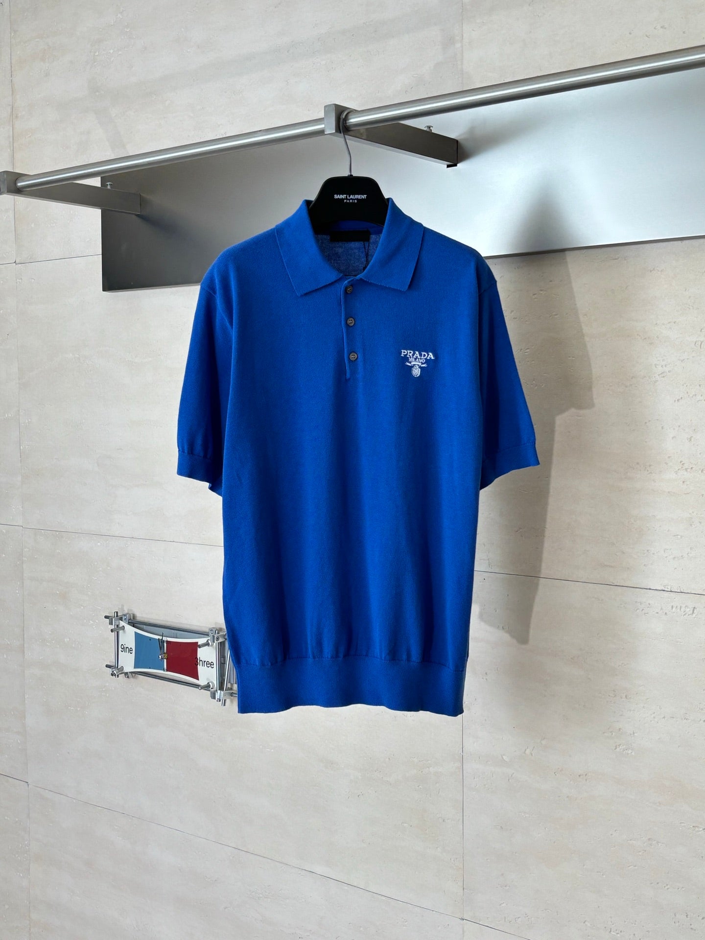 Blue short-sleeve polo shirt with Prada Milano logo on the chest