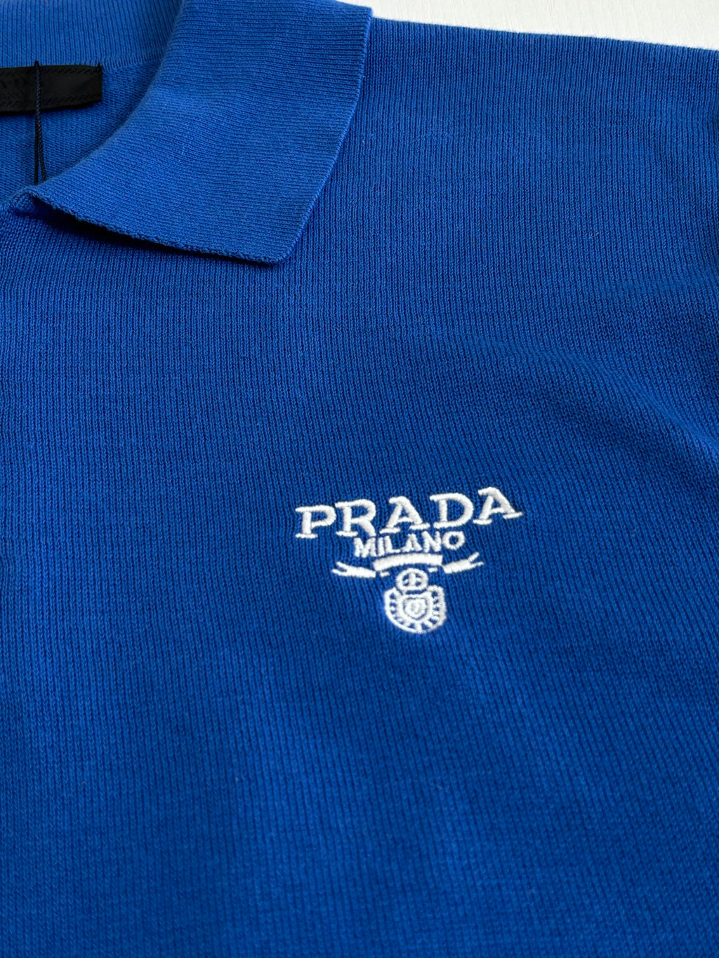 Blue knit polo shirt with Prada Milano crest logo