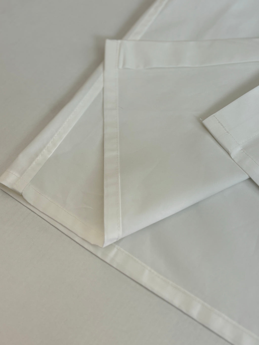 White shorts laid flat with stitched waistband and side seam