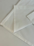 White shorts laid flat with stitched waistband and side seam