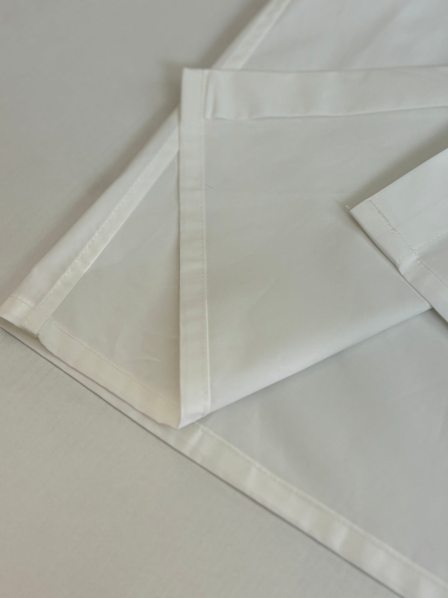 White shorts laid flat with stitched waistband and side seam