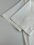 White shorts laid flat with stitched hem detail