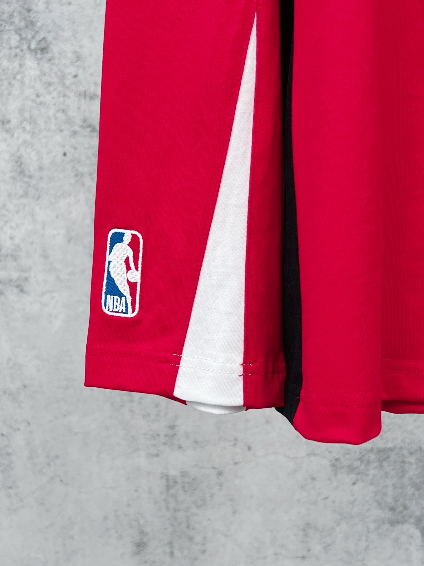 Red long-sleeve jersey sleeve with NBA player logo and white side stripe