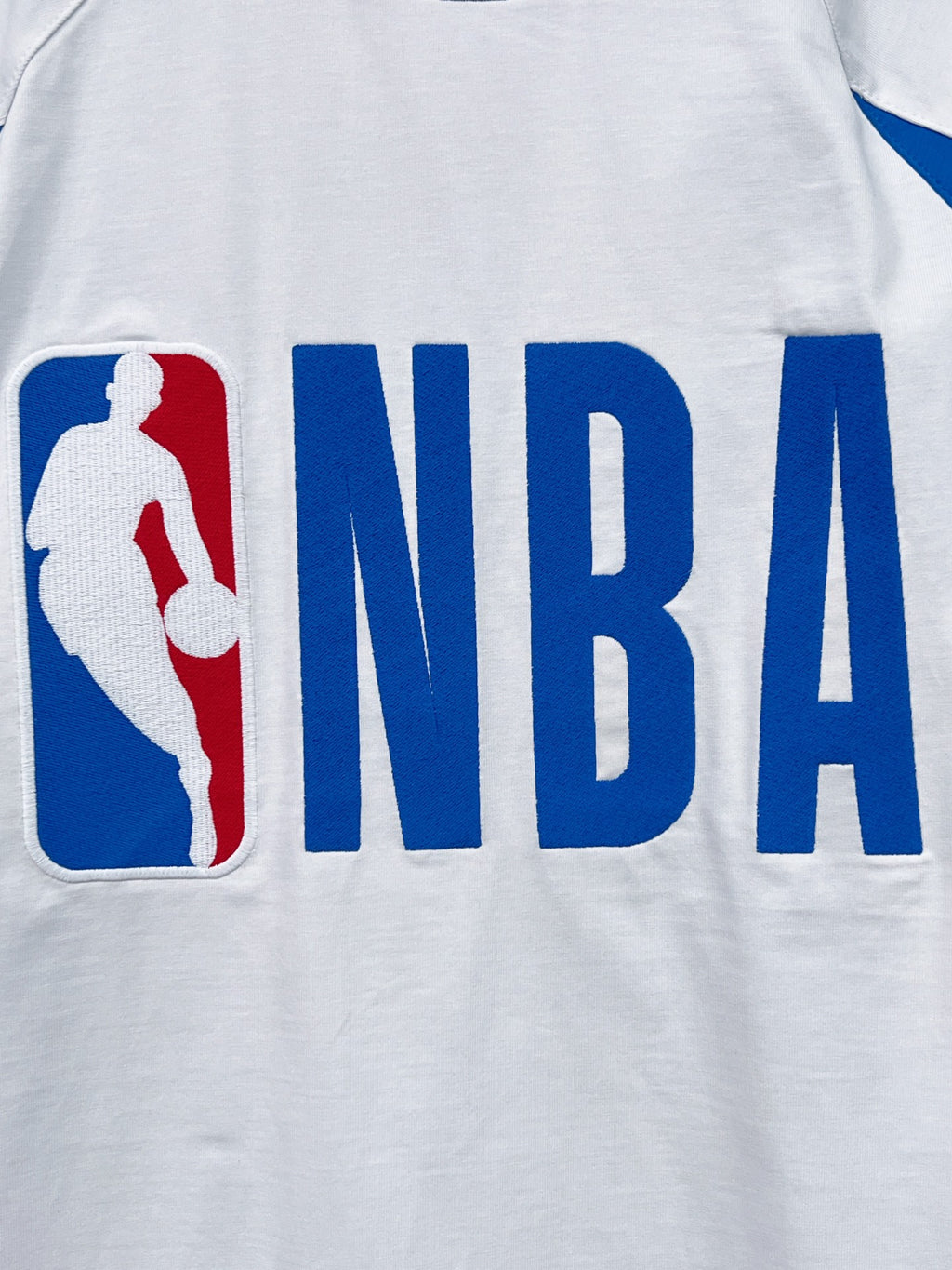 White long-sleeve T-shirt with blue NBA lettering and basketball player emblem